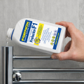Fernox Protector F1 500 ml liquid inhibitor for central heating systems in white bottle with blue cap and yellow label.