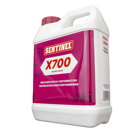Sentinel X700 Biocide 1 L additive preventing biological contamination in underfloor heating systems, white jug with red cap and pink X700 label.